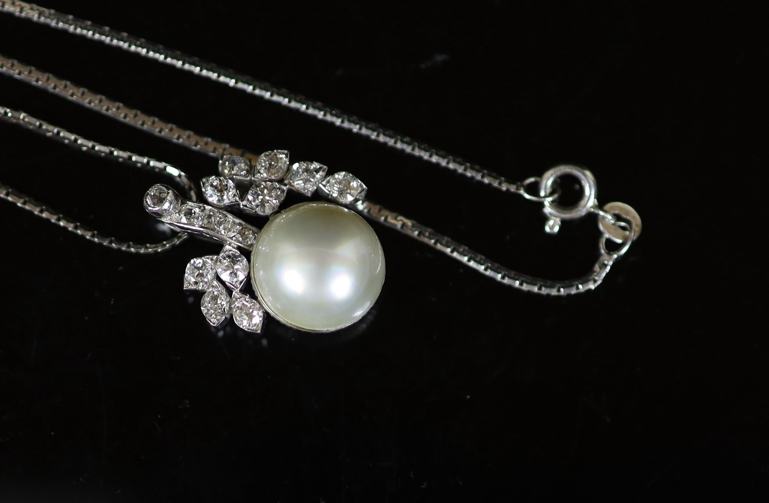 A white gold, mabe pearl and diamond cluster set pendant